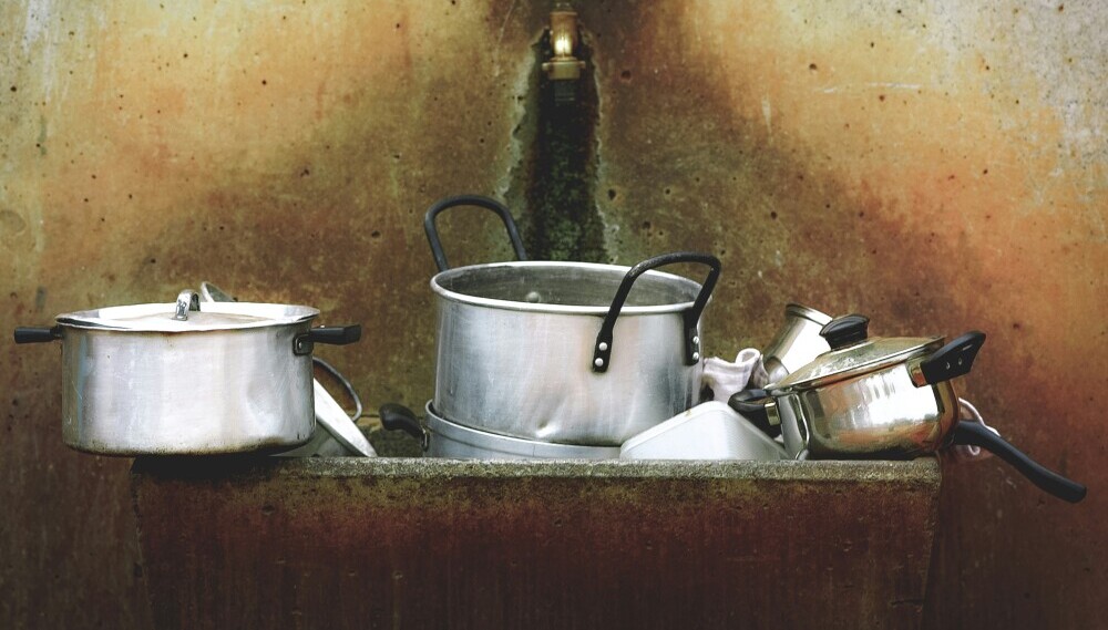 pots and pans in an old sink