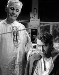 The angel, Clarence and George Bailey from the film "It's a Wonderful Life"