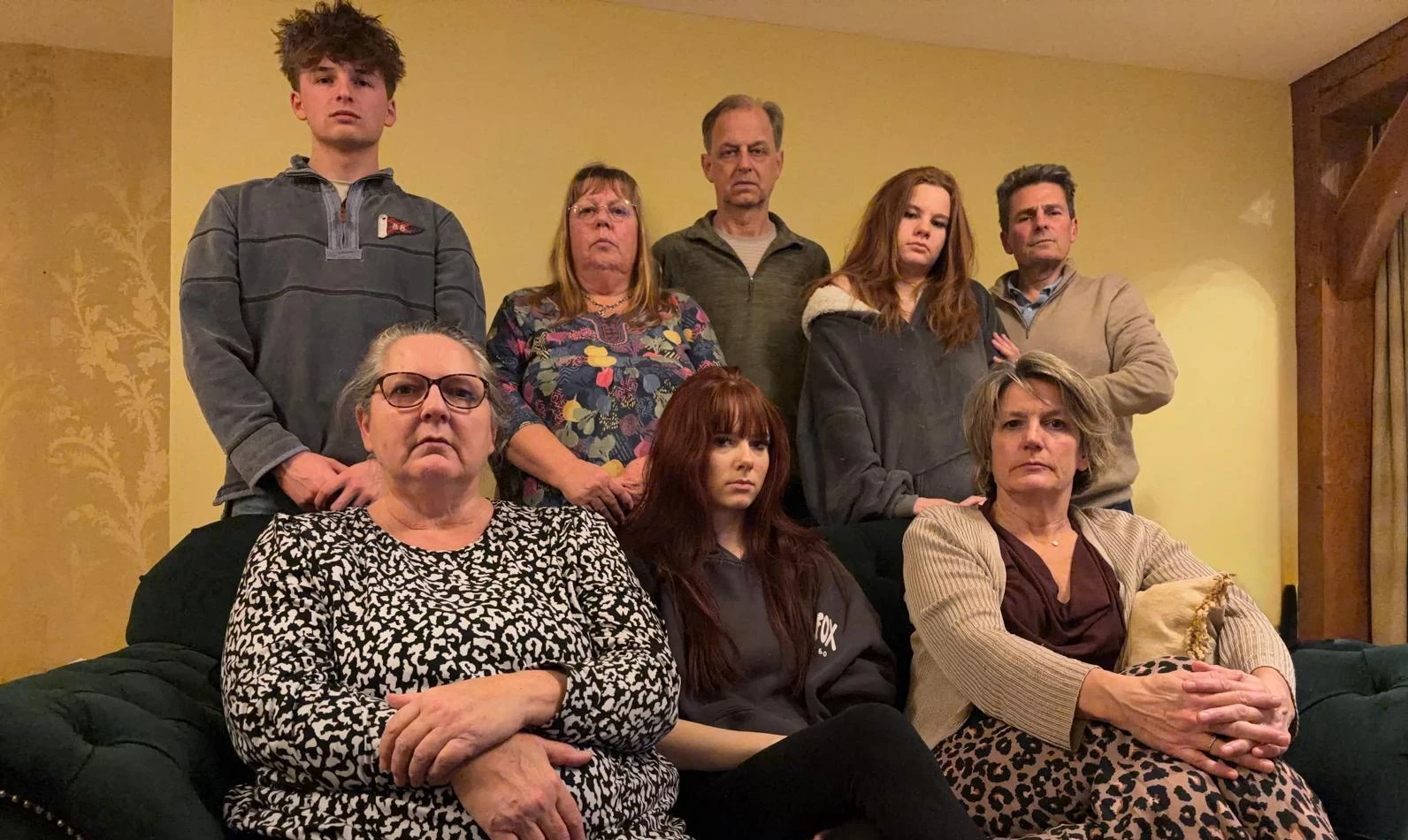 A family photo showing people staring directly at camera