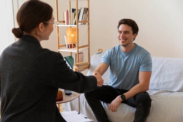 Therapist and client shaking hands at the end of a therapy session