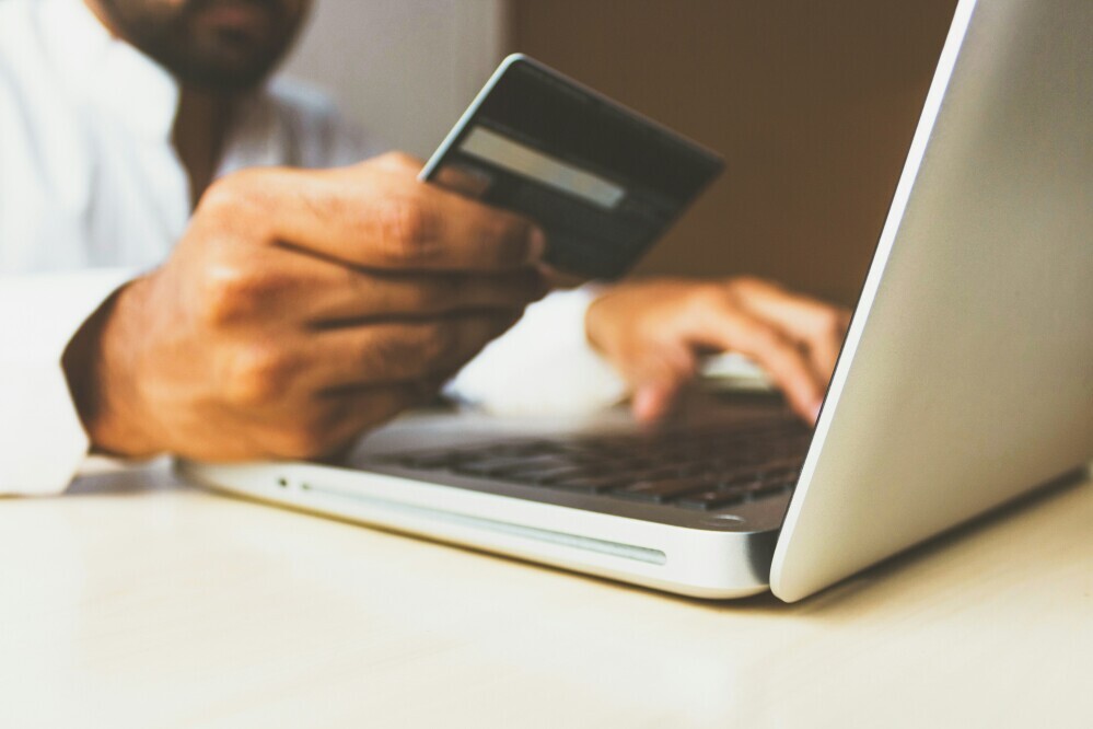 person paying online with a bank card