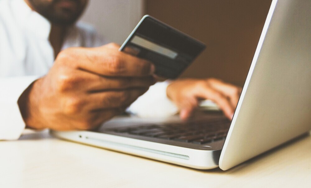 Man entering bank details on a computer for subscription-based business
