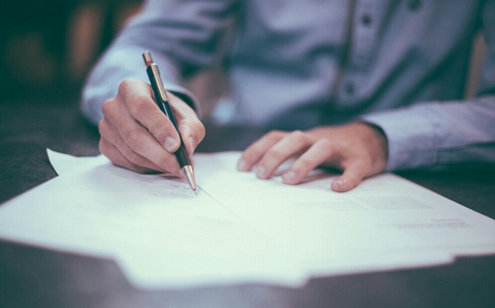 person writing an exam paper