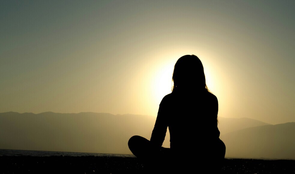silhouette of woman meditatating