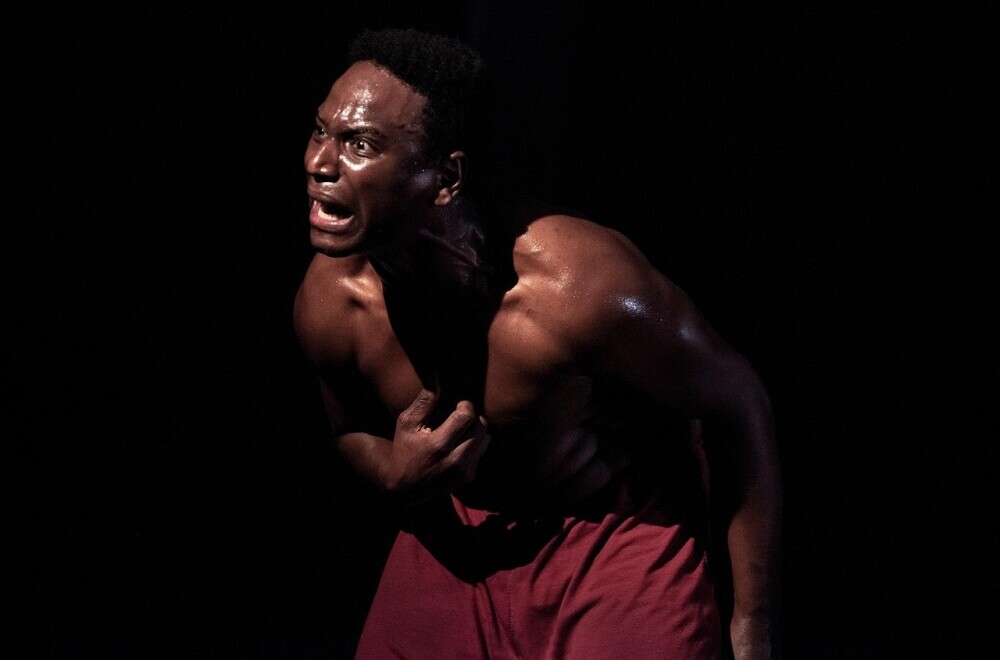 an actor on stage looking pained