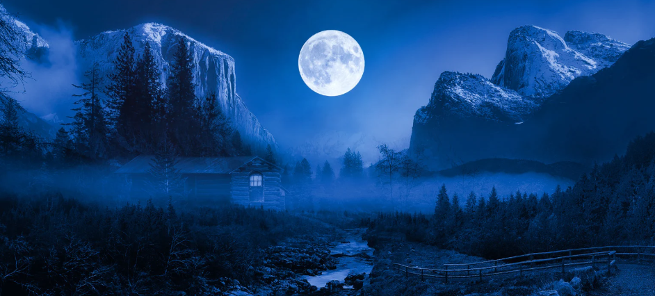 A full moon in a mountainous country