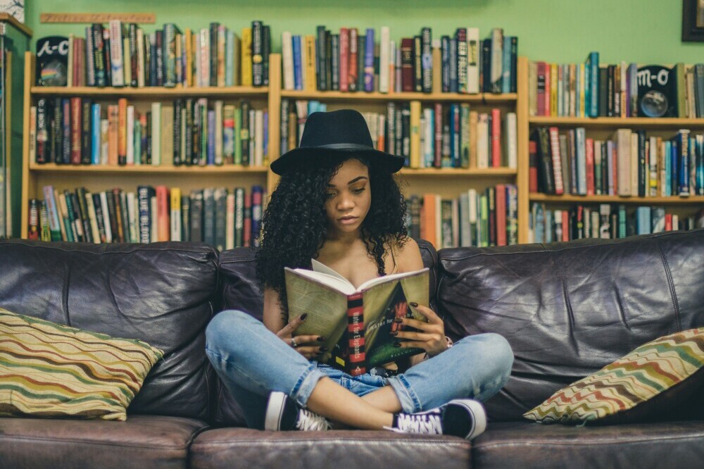 Girl in library reading a book
