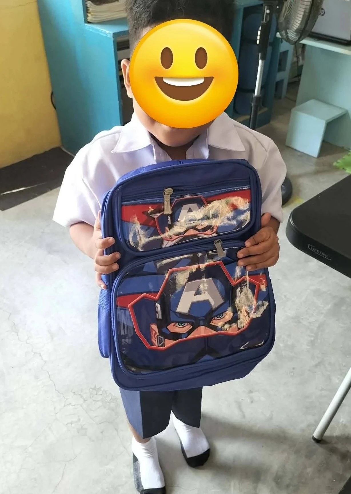 Adopt a learner project Special kid happily receiving his school bag full of school items- Adopt a learner project