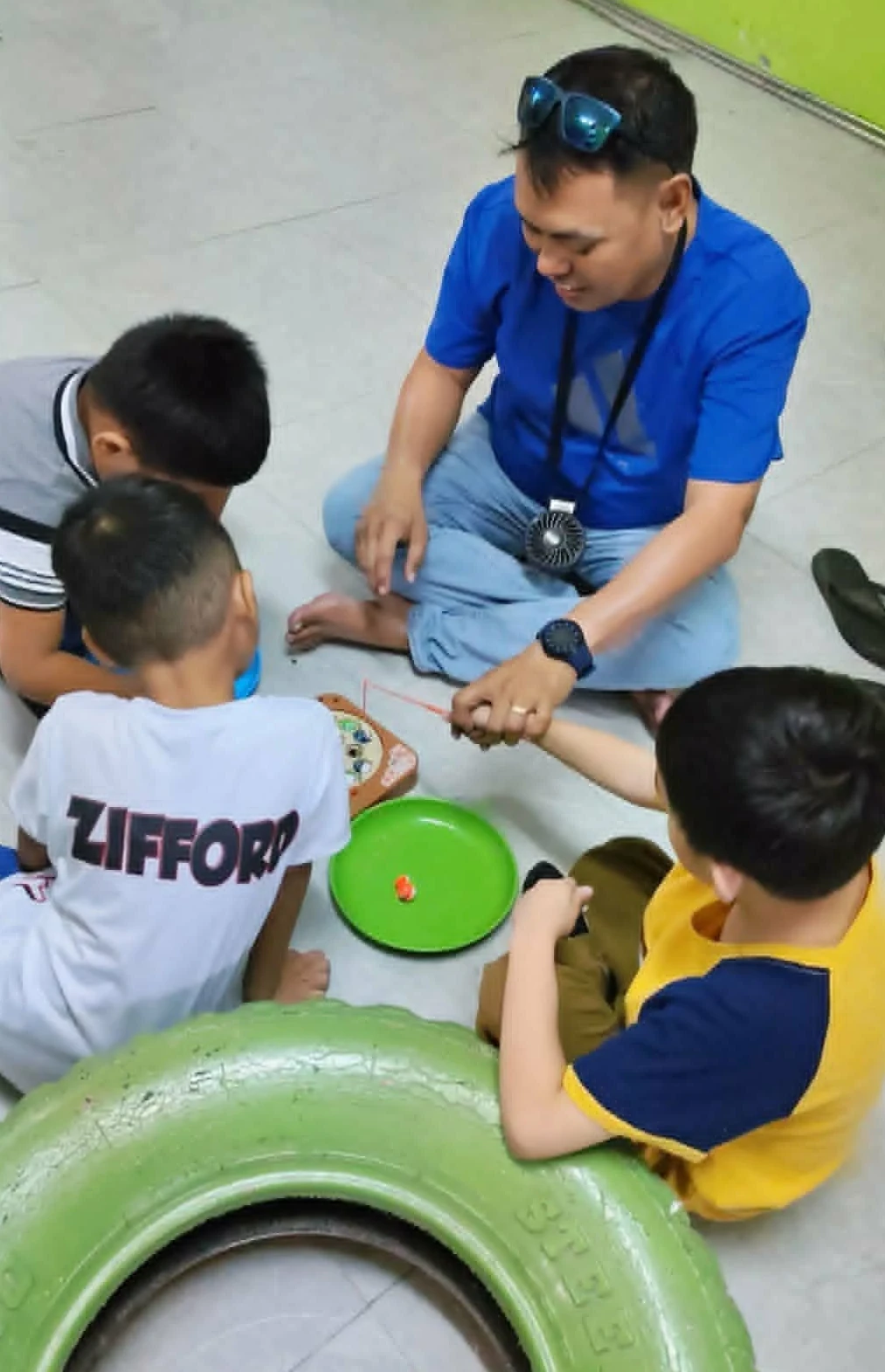 SPED teacher supervising play with special needs kids SPED teacher supervising play with special needs kids