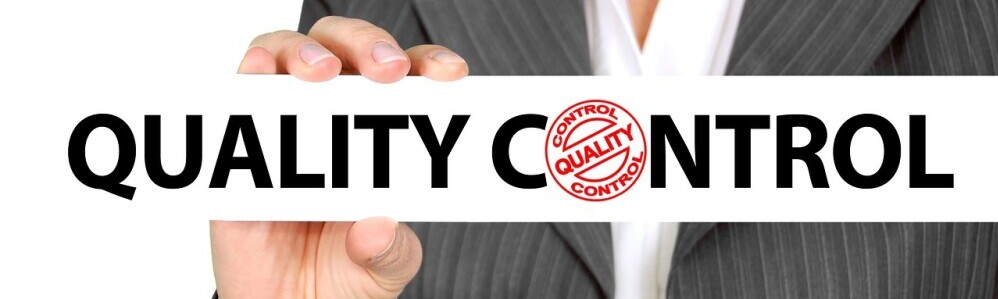 Quality Control sign held by hand