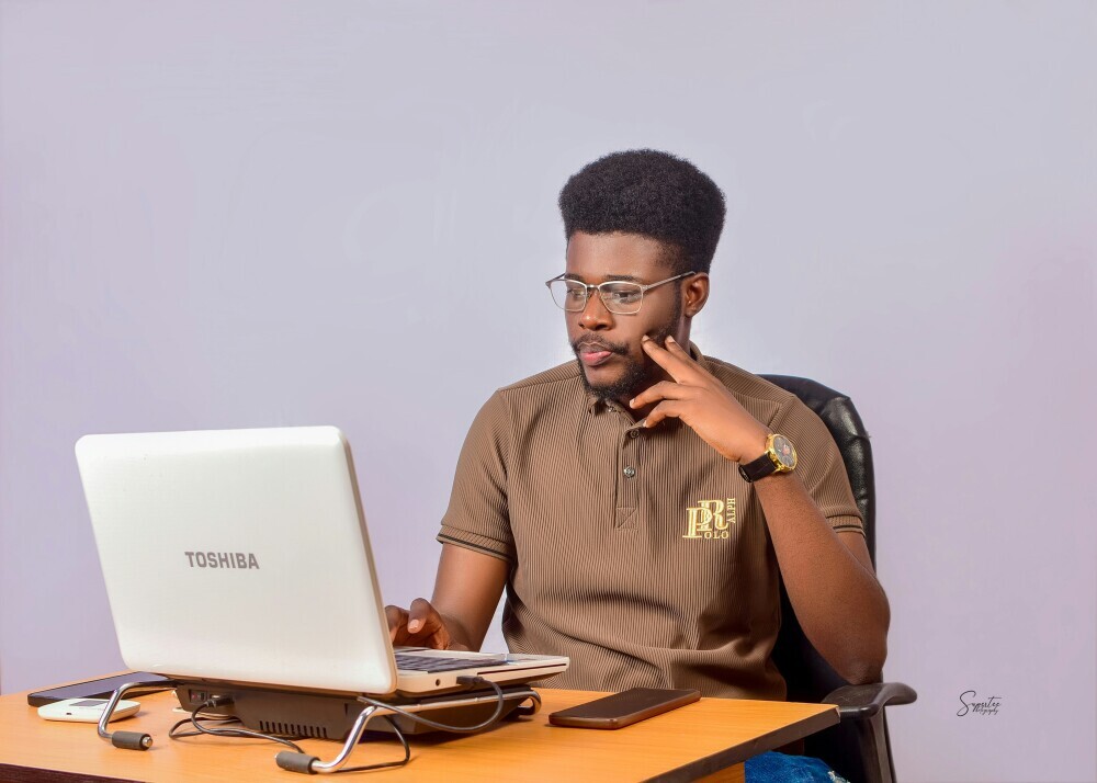 Affiliate marketer sitting at a laptop, thinking deeply and hesitating before taking action, representing overthinking and decision paralysis