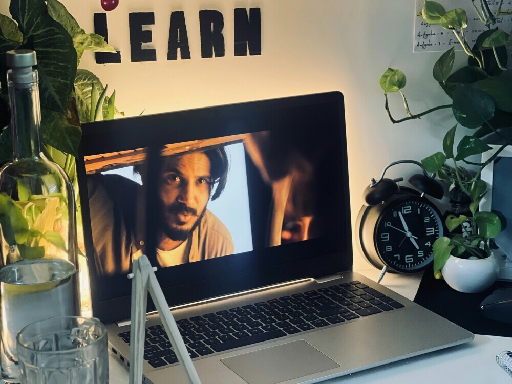 A person watching tutorials endlessly versus another applying what they learned, showing the difference between passive and active learning