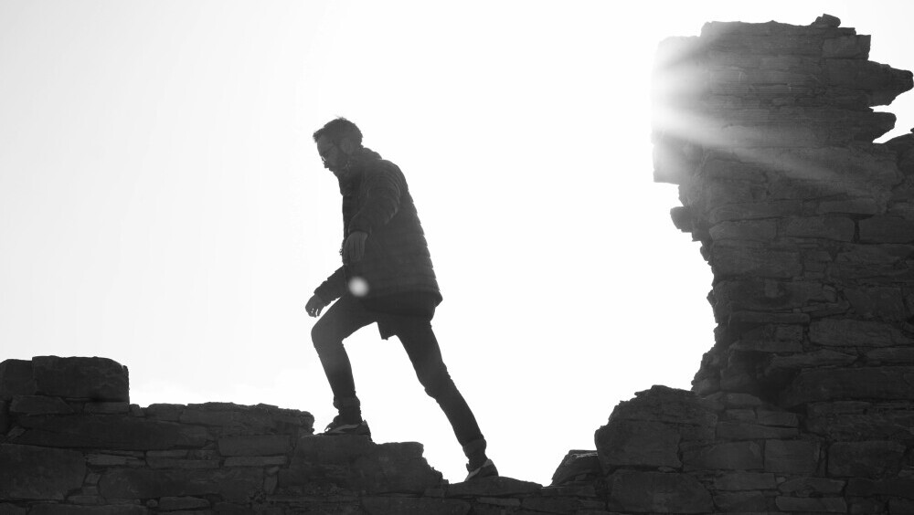 A content creator overcoming challenges and continuing forward, symbolizing growth through persistence