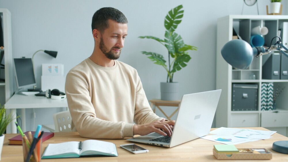 A focused blogger working on a single website project, minimal distractions, clean and organized workspace, laptop showing one niche website dashboard