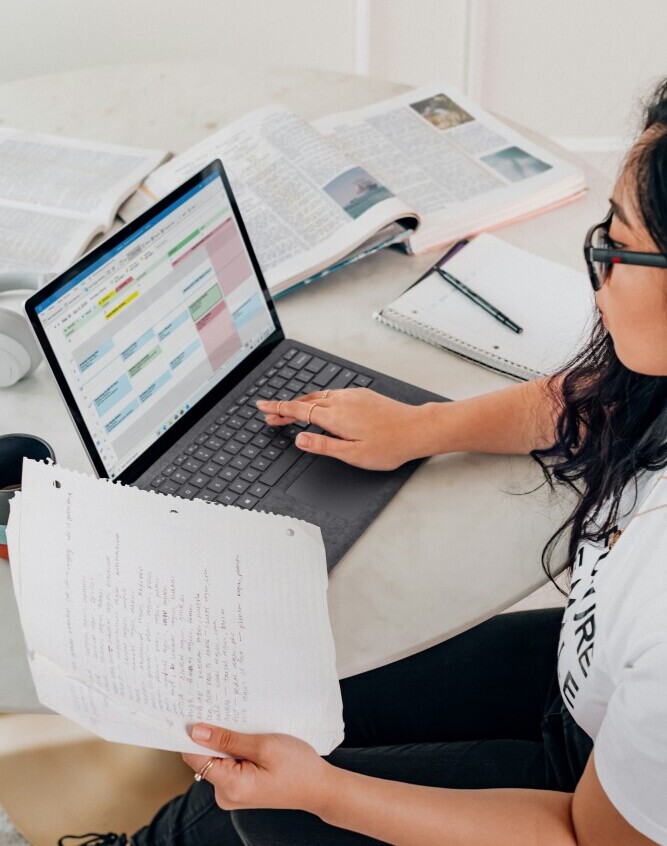 Affiliate marketer writing purposeful and structured blog content. A blogger writing a structured and purposeful article, organized notes and outline visible beside laptop