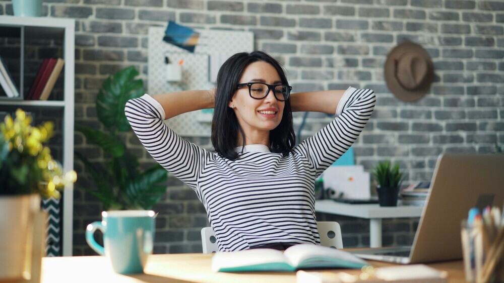 A motivated entrepreneur working with focus and confidence, positive mindset visualized through calm and productive workspace