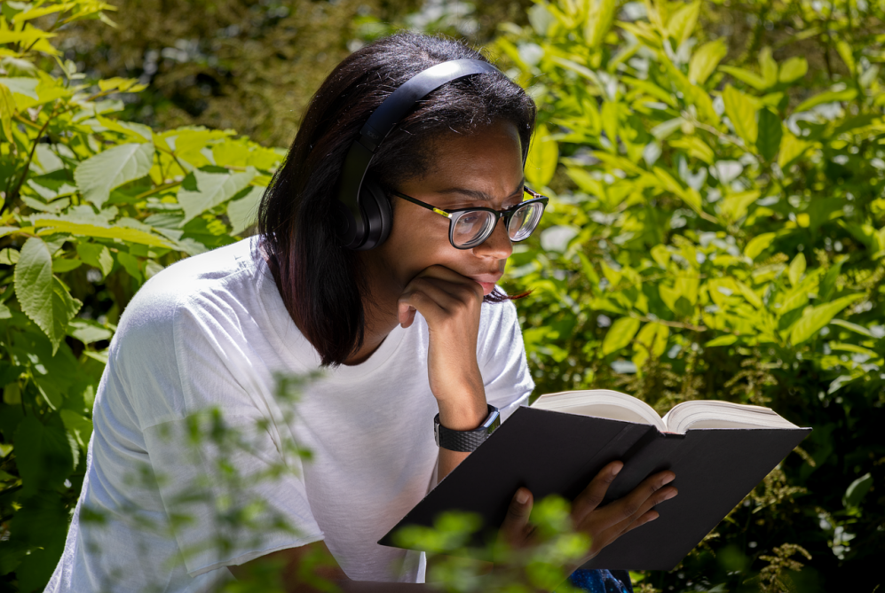 A young man interestingly reading the book with focus and concentration.