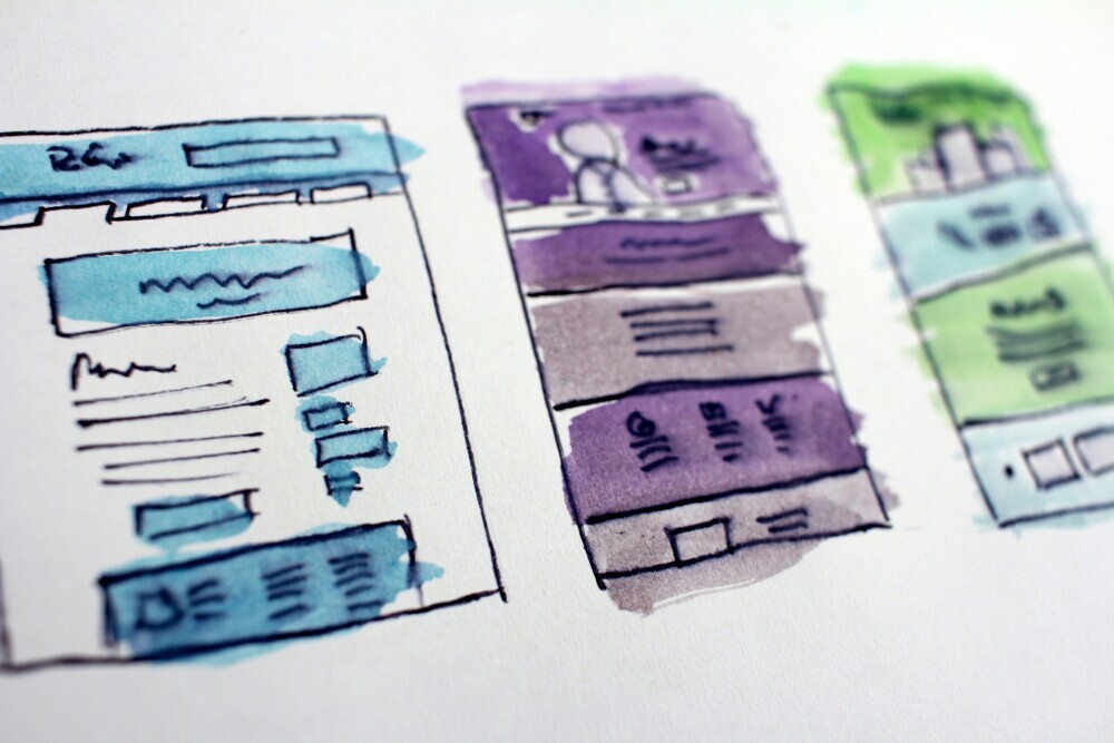 image of website design sketch on the paper.