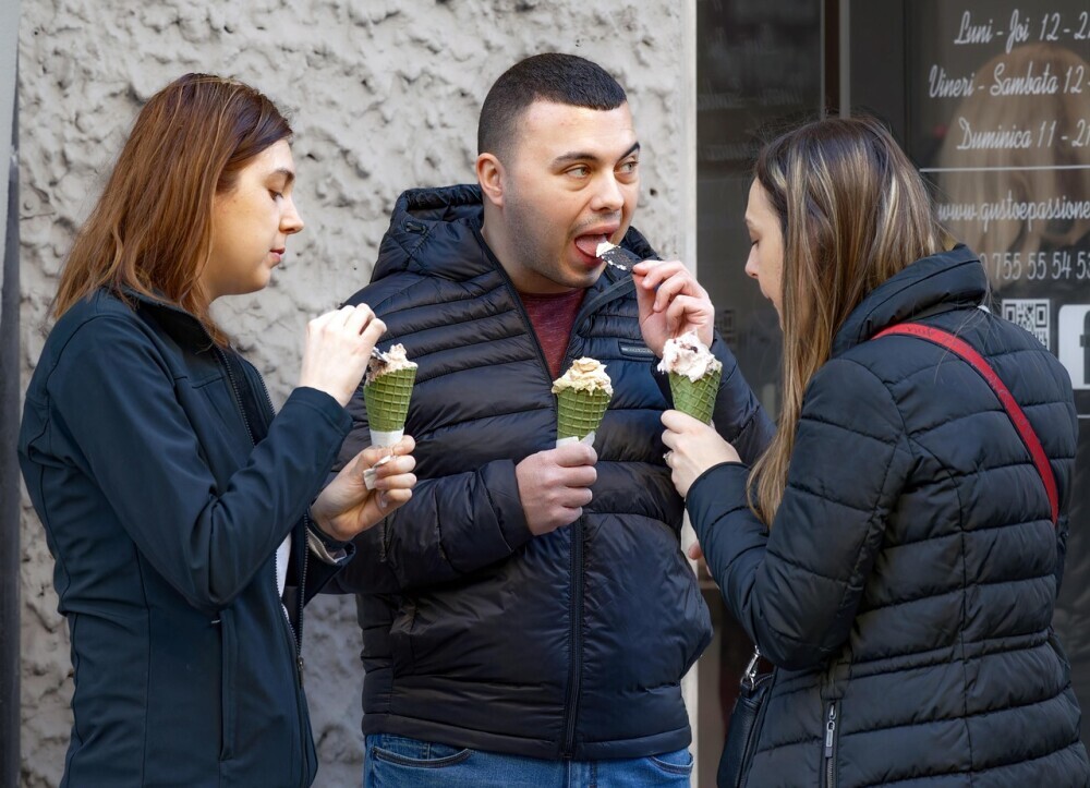 Project workers hanging out at lunch eating ice cream together to escape burnout and fatigue from work.