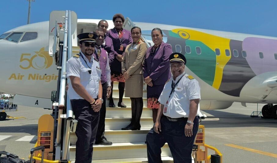 Captain Narara standing with the PNG AirNiugini Captain and airhostesses before flight.