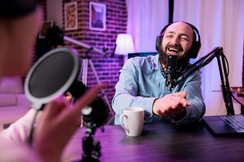 An influencer sitting behind the camera doing the live show promoting the brand.