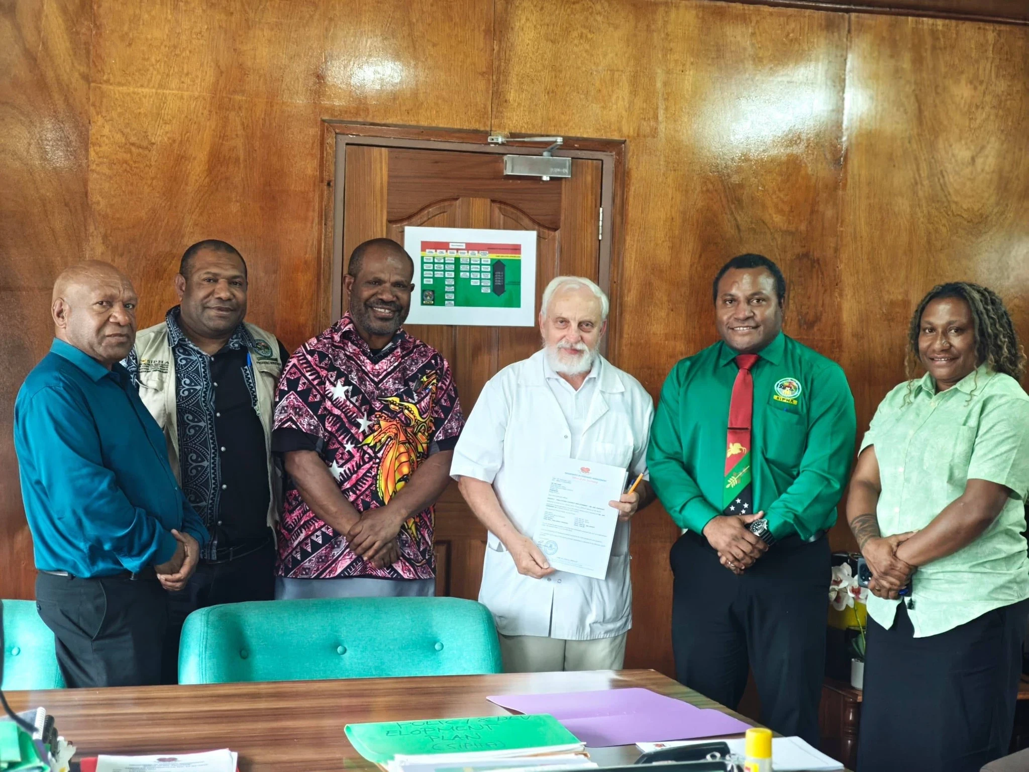 Dr. Father Jan Jaworski signing a specialist consultant contract with Simbu Provincial Health Authority, marking the continuation of his 30-year medical service legacy.