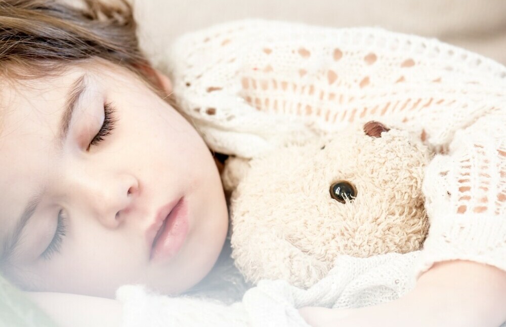 little girl sleeping with her 'teddie'