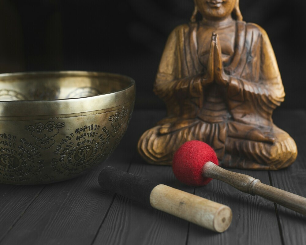 items to raise your vibrational state; a bowl for burning sage and a mini statue of buddha