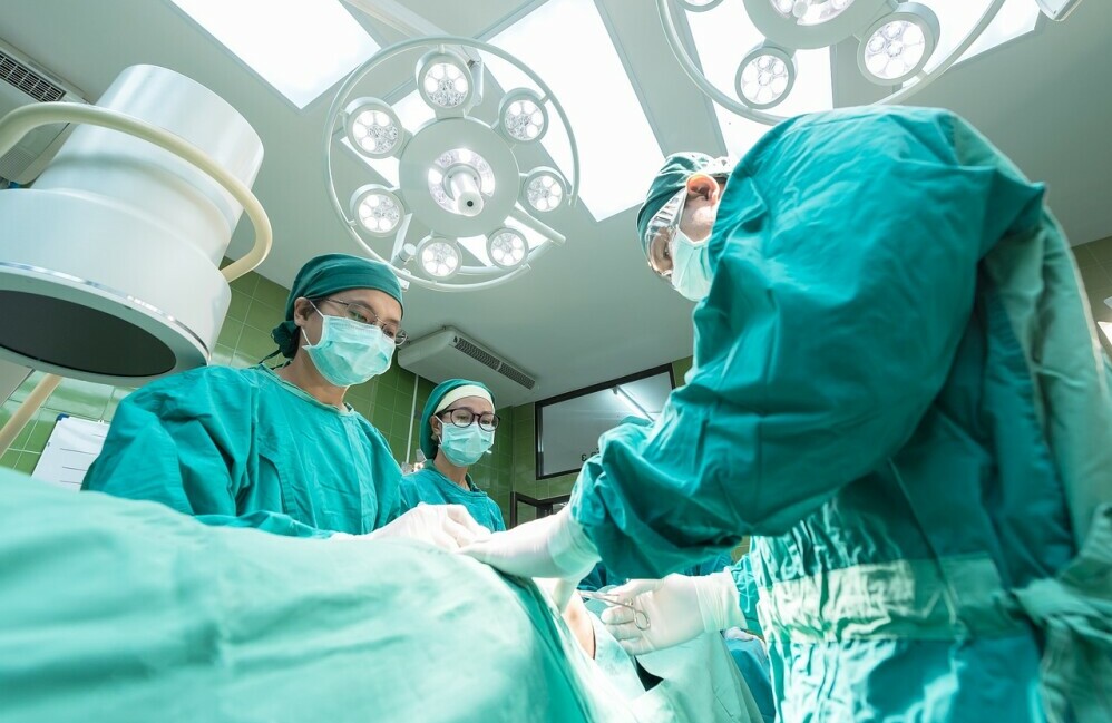 team of doctors performing surgery