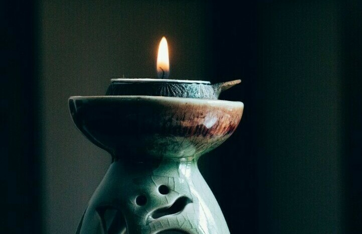burning candle in a holder for meditation