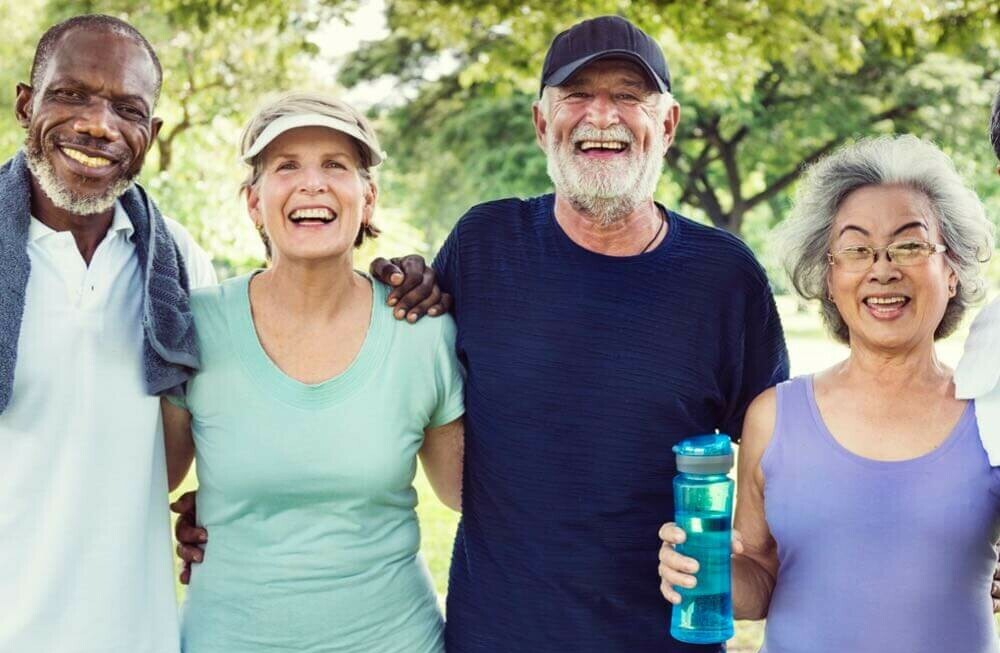 two senior couples out walking in nature