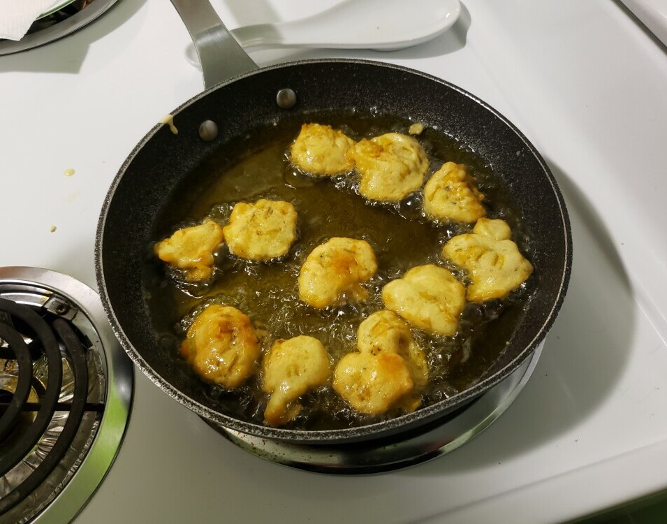 dandelion flower fritters frying in the pan