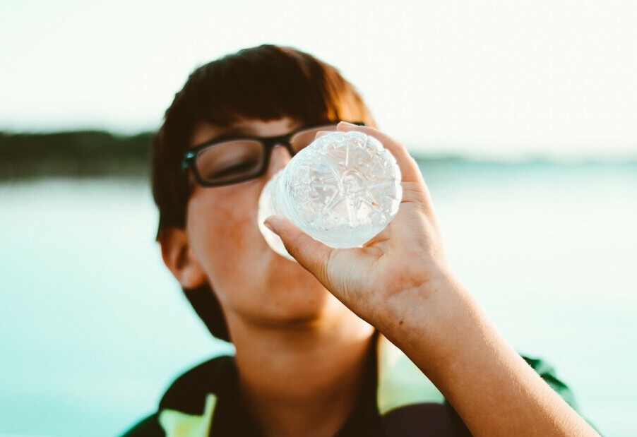 teenage boy drinking water