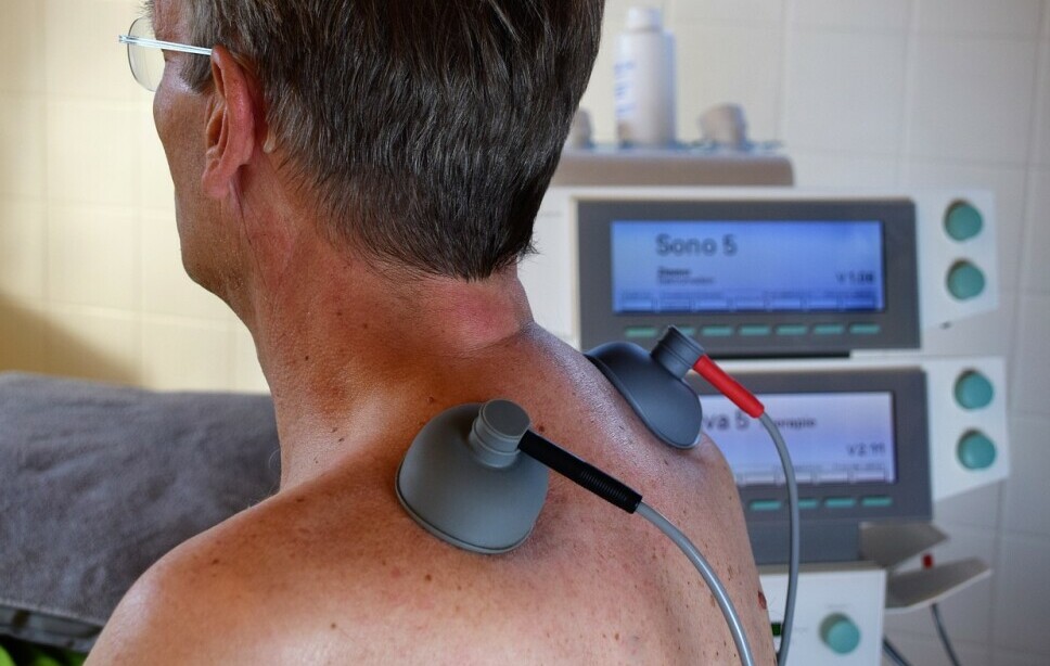 man receiving electronic massage therapy