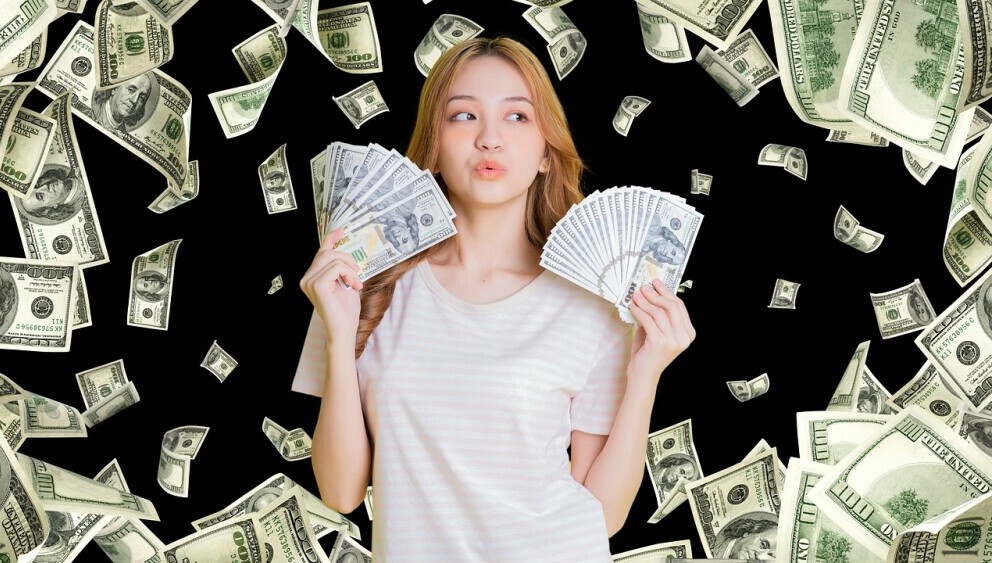 law of attraction: money raining down on young woman