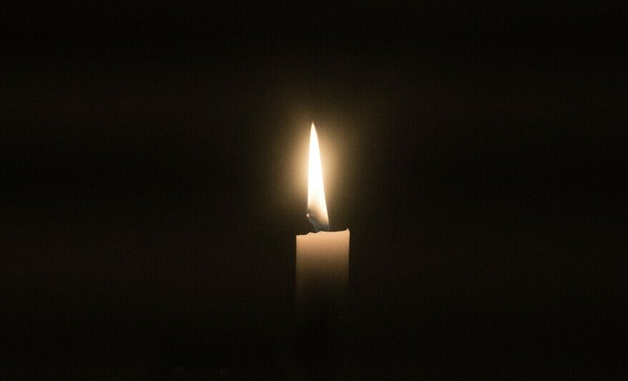a candle burning in the dark