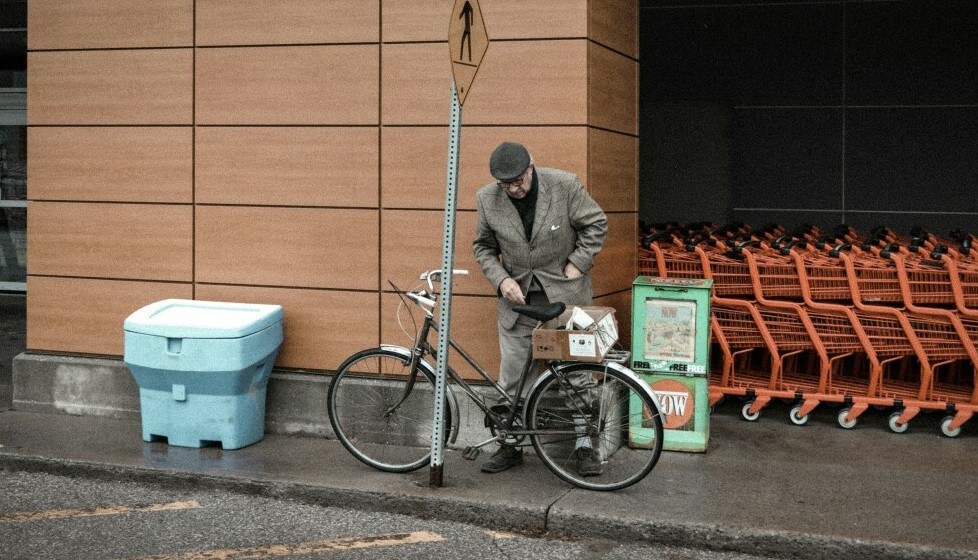 senior man staying health by bicycling to the grocery store