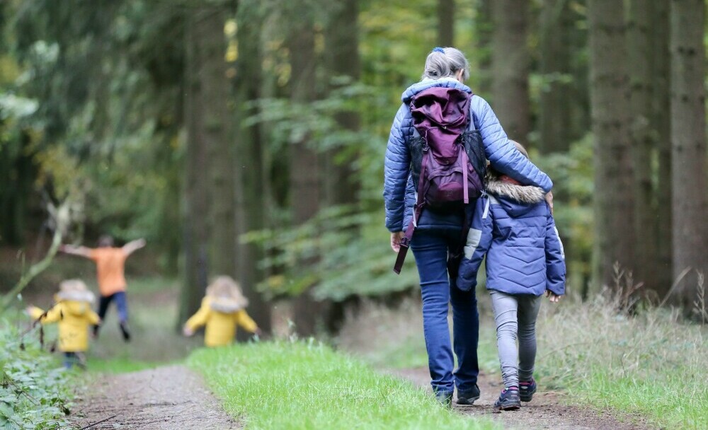 mother walking with her children in nature