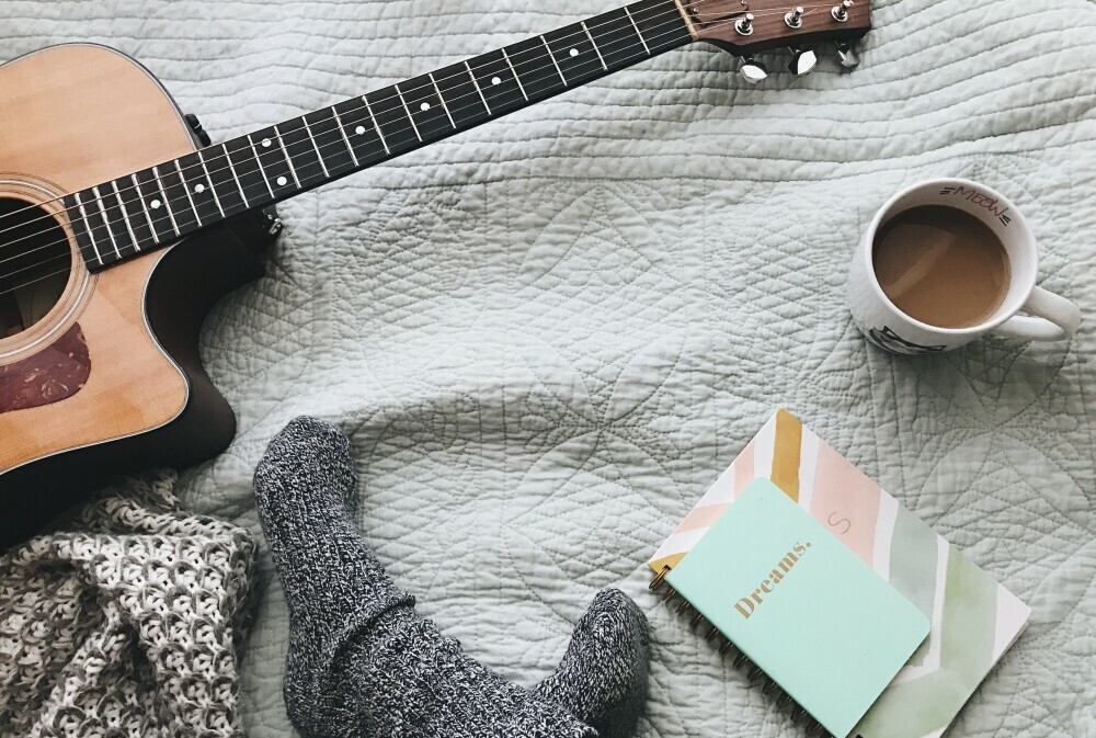 Cozy space with guitar  and hot chocolate