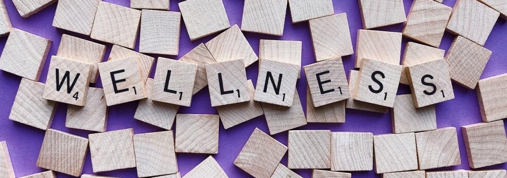 tiled letters that spell out wellness
