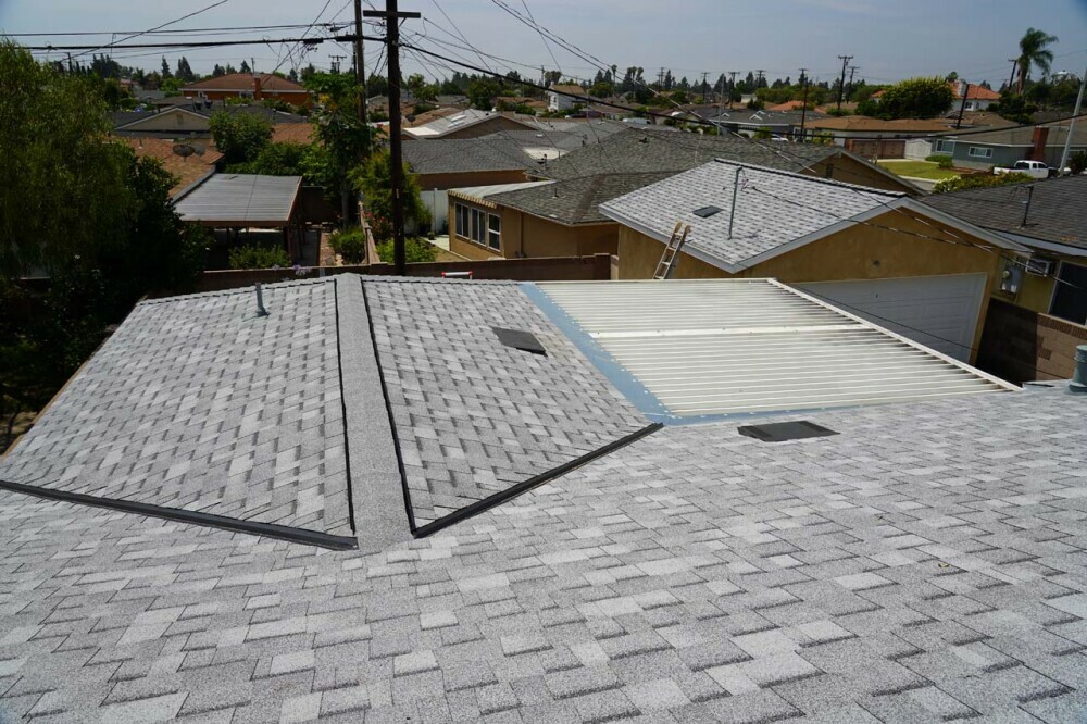 Looking down at the reflective asphalt shingle with ridge vents and O'Hagin vents installed for passive air circulation by convection