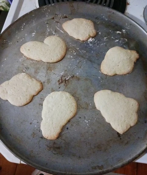 Sugar cookies with Christmas shapes, still on the pan