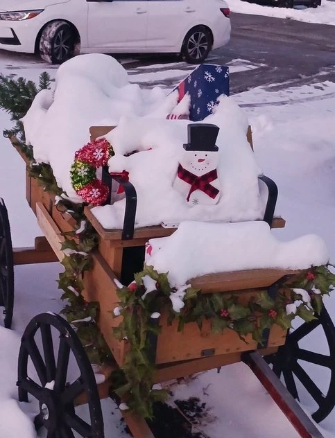 Christmas wagon with white car parked nearby