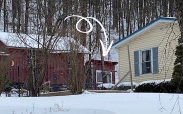 Chicken coop pointed out by white arrow