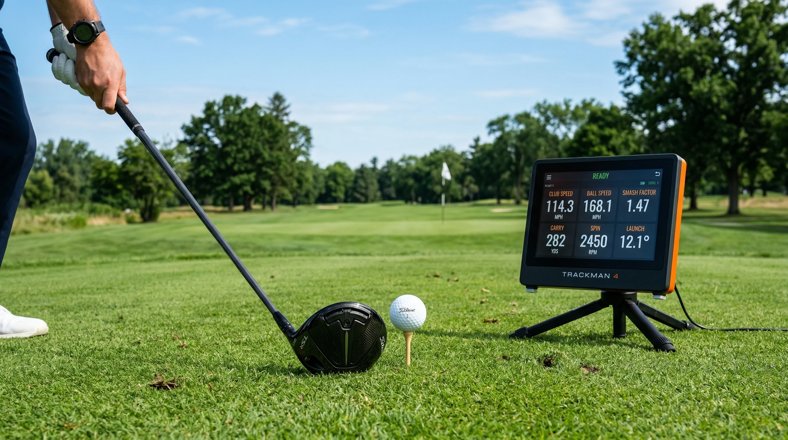 Golf driver club and ball on tee against golf course background
