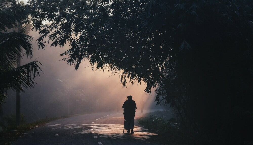 a person walking along the road in the morning finding peace through nature walks and grounding