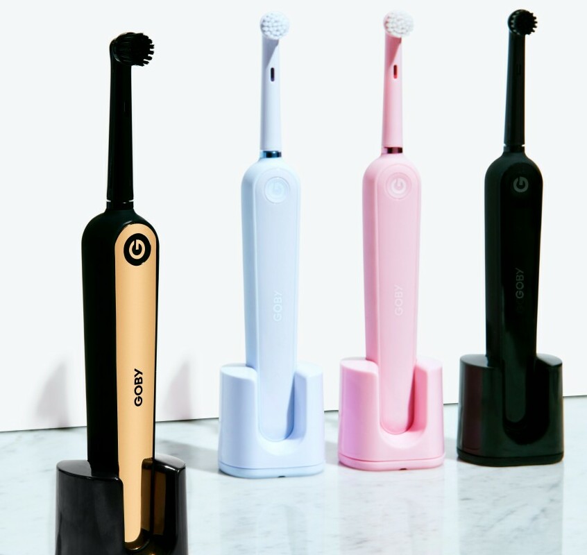 four different coloured electric toothbrushes