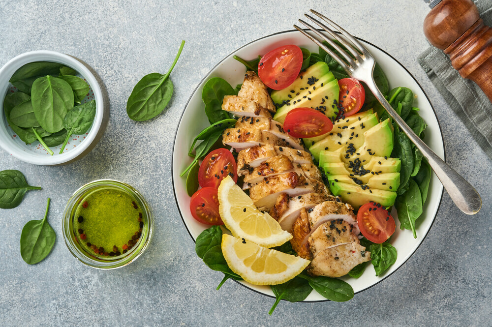 fresh green slad with grilled chicken, avocado, and avocado oil