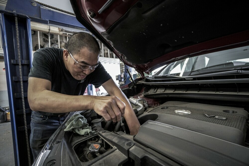 auto mechanic working on car