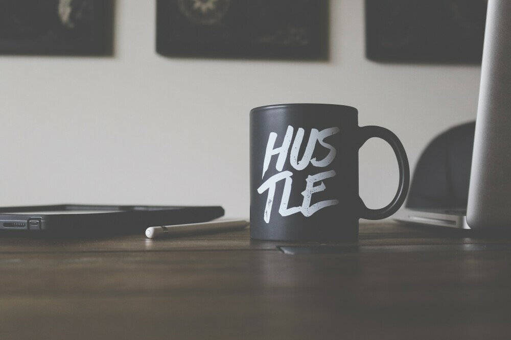 mug with hustle written on it